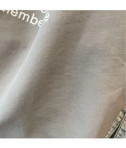 Detailed macro view of lightweight grey washed canvas fabric with fine horizontal texture