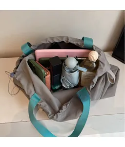 Spacious interior of gray tote bag showing storage for tablet, phone, and umbrella