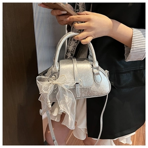 Silver metallic shell bag with elegant lace pearl bow detail and sleek top handle
