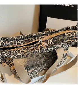 Detail of leopard print tote bag showing smooth metal zippers and multi-layer compartments