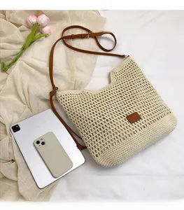 Flat lay of hollow woven shoulder bag showing large capacity for iPad and phone