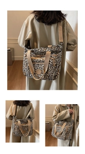 Detail view of large leopard print tote bag featuring zip pockets and adjustable straps