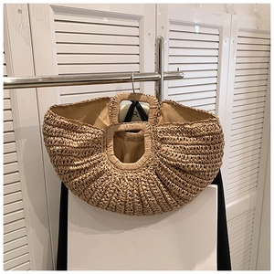 Detail of a semi-circular straw bag showing the weave texture and fabric lining