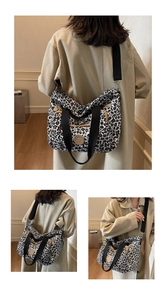 Detail of leopard print tote bag featuring black woven straps and a round logo badge