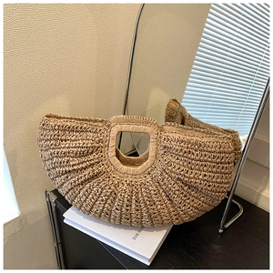 Detail of handmade straw woven handbag showing thick texture and integrated handle