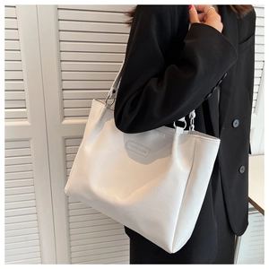 Close-up of white pebble grain faux leather tote bag with Fashion & Bag label