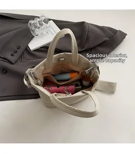 Interior view of off-white tote bag showing spacious compartments and zipper pockets