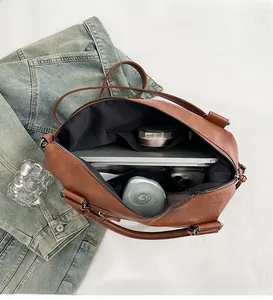 Spacious interior of caramel faux leather tote showing laptop and phone storage capacity