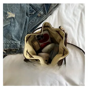 Top view of straw bucket bag interior showing large capacity for phone and cosmetics