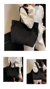 Detail of a large black tote bag with multiple pockets for daily commuting and campus use