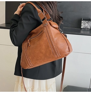 Detail of vintage brown tote bag showing textured faux leather and woven design accents