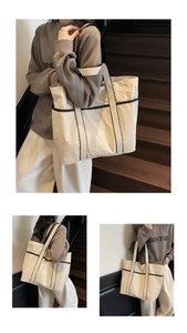 Detailed views of a minimalist cream canvas tote bag with black contrast piping on stairs