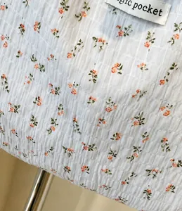 Detailed macro of floral smocked fabric texture on this large stylish tote bag