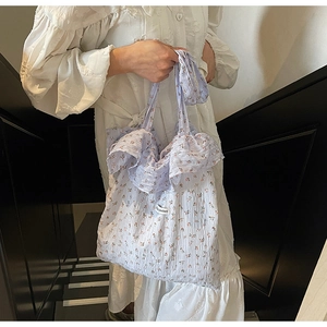 Detail of lavender floral fabric tote bag featuring textured ruffles and small flower patterns