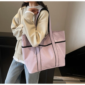 Detail of light purple large tote bag with black geometric lines for daily commute