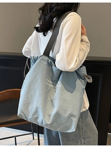 Minimalist light blue drawstring tote bag with letter print and wide shoulder straps