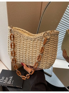 Handmade straw shoulder bag with amber acrylic chain strap and minimalist crescent shape