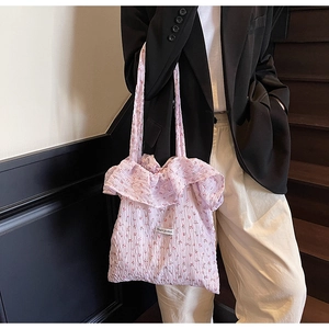 Detail of lavender floral tote bag with ruffled trim and Magic Pocket woven label