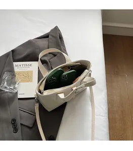 Top-down view of cream white bucket bag interior showing capacity for two smartphones