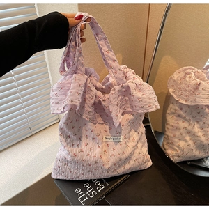 Detail of floral tote bag with ruffled texture and Magic Pocket label in lavender