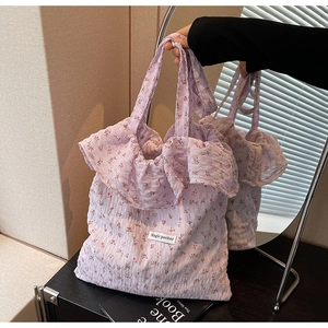 Detail of lavender floral tote with ruffle edges and Magic Pocket label on puckered fabric