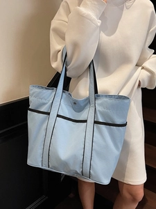 Light blue large canvas tote bag with black strap details for daily commute and students