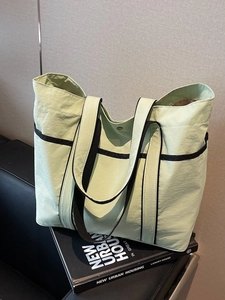 Large pale green nylon tote bag with black trim for work or college students