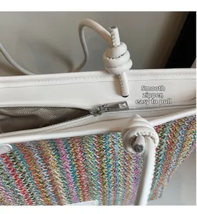 Detail view of smooth metal zipper and colorful woven texture on striped tote bag