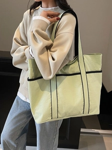 Minimalist light green large tote bag with black trim for commuting and daily use
