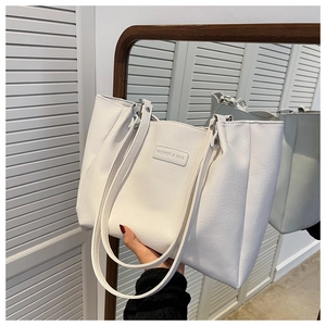 Close-up of white tote bag with lychee grain leather texture and Fashion & Bag logo