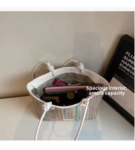 Detail view of colorful straw tote bag showing spacious interior with personal essentials