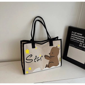 Gros plan du sac cabas en toile beige avec motif d'ours mignon et imprimé étoiles