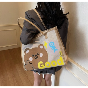 Détail d'un grand sac cabas en toile avec ours imprimé et sangle marron élégante