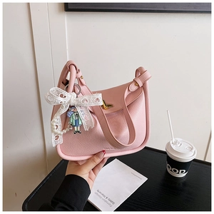 Pink lychee texture leather handbag featuring lace bow and pearl charm details