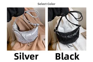 Detail view of crescent crossbody bags in silver and black with ruched texture