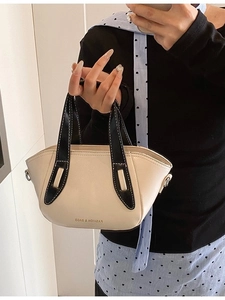 Beige contrast mini crossbody bag with black handles and top-stitching details