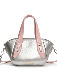 Silver metallic crossbody pillow bag with pink handles and adjustable shoulder strap