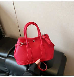 Detailansicht der roten Handtasche aus Leder mit Kieselmaserung und Silberbeschlägen