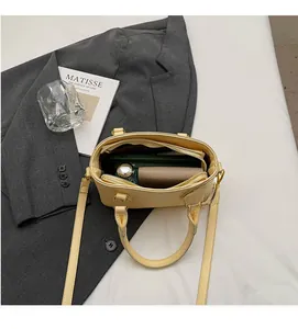 Interior view of light yellow leather bucket bag showing spacious storage for essentials