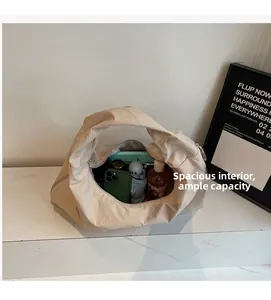 Detail shot of a spacious beige tote bag interior showing ample storage for daily items