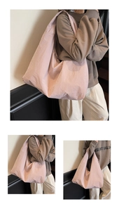 Detail of light pink nylon tote bag showing soft crinkled texture and large capacity