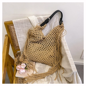 Detail of hand-woven hollow mesh texture and long tassels on khaki crochet tote bag