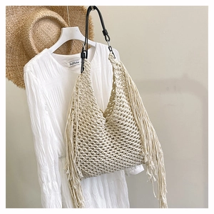Bohemian beige hand-woven tote with long tassels and black leather shoulder strap