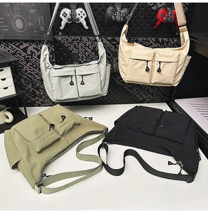 Nylon messenger bag featuring dual buckle flap pockets and adjustable wide shoulder strap