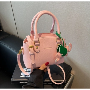 Pink lychee grain leather shell bag with gold hardware and creative animal charm