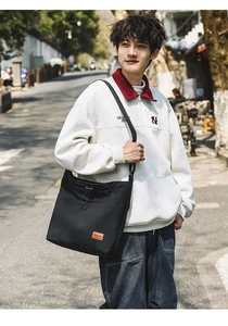 Outdoor-Street-Shot der schwarzen Nylon-Tasche mit Kordelzugtasche und Lederetikett