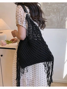 Handmade black woven tote bag with fringe tassels and leather shoulder strap for women