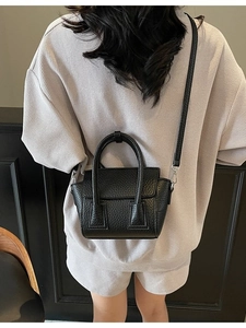 Chic black litchi pattern leather crossbody bag shown on model for daily style
