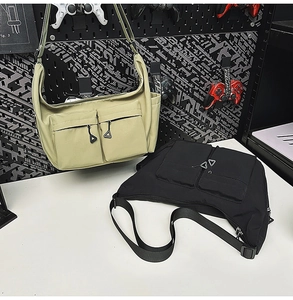 Detail showing tactical nylon messenger bags with double zip pockets and techwear style