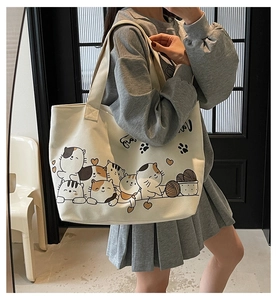 Detail of cute cartoon cat illustrations on large off-white canvas tote bag